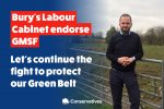 James Daly stands in a field, leaning on a gate. The left of the image fades to a dark blue. Overlaid, in a red box in white writing it says "Bury Labour Cabinet endorses GMSF". Below this in white writing it says "Let's continue the fight to protect our Green Belt"