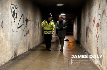 James Daly MP walks with Police Officer