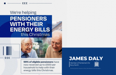 An advertisement featuring a message about financial support for pensioners with energy bills during Christmas. It includes text saying "We're helping PENSIONERS WITH THEIR ENERGY BILLS this Christmas" and "99% of eligible pensioners have now received up to £600 per household to help with their energy bills this Christmas." A photo of an elderly couple smiling and reading a document is shown. On the right side, there is a blue section with the text "JAMES DALY Member of Parliament for Bury North